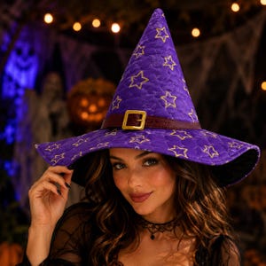 May include: A purple quilted witch hat featuring a pattern of yellow embroidered stars. The hat includes a dark brown faux leather band around the base with a gold-toned metal buckle. The fabric has a textured, stitched diamond pattern throughout.