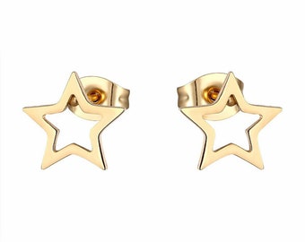 May include: A pair of gold-toned star-shaped stud earrings. The stars have an open design, with a smaller star shape cut out from the center of each star.