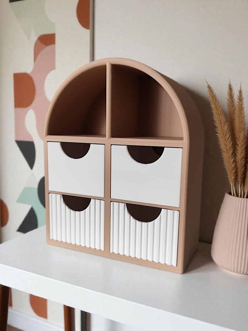 May include: A beige arched desktop organizer featuring two open top compartments and four drawers. The top two drawers have smooth white fronts, while the bottom two drawers feature a vertical ribbed texture. Each drawer has a semi-circular cutout.