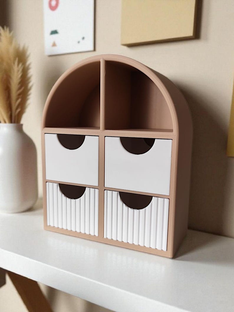 May include: A beige arched desktop organizer featuring two open top compartments and four drawers. The top two drawers have smooth white fronts, while the bottom two drawers feature a vertical ribbed texture. Each drawer has a semi-circular cutout.