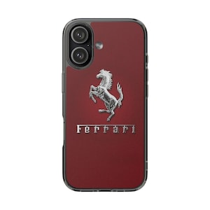 May include: A dark red smartphone case featuring a silver-colored prancing horse emblem centered above the silver text Ferrari. The case has a clear border and cutouts for the dual camera lenses and flash on the upper left side of the device.
