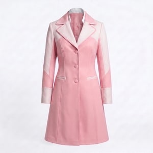May include: A knee-length coat in shades of pink, featuring a structured collar, long sleeves with contrasting light pink cuffs, and a three-button front closure. The design includes vertical seams and two horizontal welt pockets on the front.