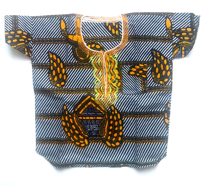 May include: A white, black, and yellow patterned short-sleeved shirt with a round neckline. The shirt has a geometric design with a central motif.