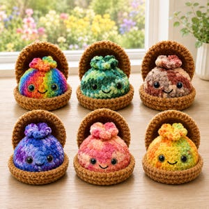 May include: Six round, crocheted plush toys, each nestled in a brown, bowl-shaped base. The plushies feature varied color patterns including rainbow, green, brown, blue, pink, and yellow, all with black plastic eyes and stitched smiles.