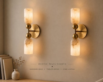 May include: Two wall-mounted light fixtures featuring brushed brass hardware and two cylindrical, marbled glass shades each. The text RUSTIC WALL LIGHTS, HANDMADE BRASS, TIMELESS DESIGN, HOME LIGHTING is printed between the two light fixtures.