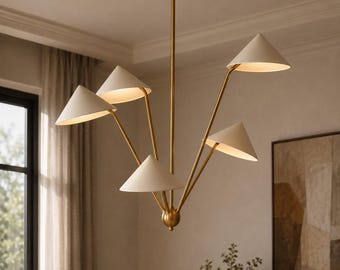 May include: A multi-arm chandelier featuring a central brass-toned rod and five conical off-white shades. The arms extend outward at varying angles from a central spherical brass base, each supporting a single light source directed downward.