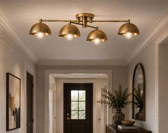 May include: A ceiling-mounted light fixture featuring a central brass-toned hub with four horizontal arms extending outward. Each arm terminates in a downward-facing, semi-spherical brass shade, each housing a single exposed light bulb.