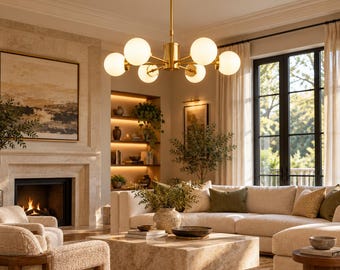 May include: A brass chandelier featuring six spherical white glass globes arranged in a radial pattern. The fixture is suspended from the ceiling by a central rod and includes a circular canopy, providing illumination to the surrounding room.