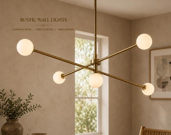 May include: A brass chandelier featuring five arms extending from a central vertical rod, each ending in a spherical white glass globe light. The text RUSTIC WALL LIGHTS, HANDMADE BRASS, TIMELESS DESIGN, HOME LIGHTING is visible in the upper left corner.