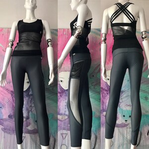 May include: A black mesh and solid athletic top with a criss-cross back detail, paired with dark gray leggings featuring a mesh panel on the left leg.
