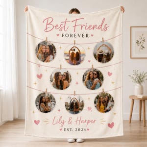 May include: A cream-colored fleece blanket featuring the text Best Friends FOREVER and Lily & Harper EST. 2024. The design includes eight circular photo frames suspended by illustrated clothespins on lines, accented with small pink hearts and stars.