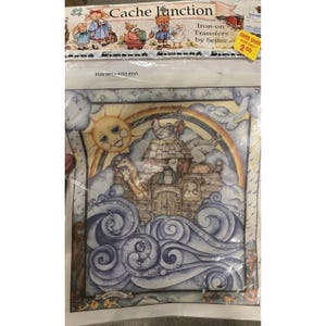 May include: A Cache Junction iron-on transfer package titled Fun with Foo Foo featuring a Noah's Ark illustration with a wooden boat, various animals, a smiling sun, a rainbow, and swirling blue waves on a clear plastic sheet with text.