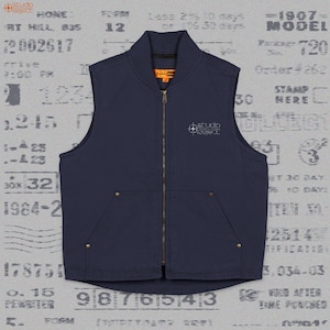 May include: A navy blue sleeveless vest with a full-length front zipper, a stand-up collar, and two front pockets reinforced with metal rivets. The chest features the embroidered text "studio reject" and an orange interior neck label.