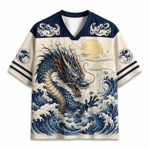 May include: A short-sleeve V-neck jersey featuring a large graphic of a blue dragon emerging from stylized ocean waves under a pale yellow moon. The shirt has a cream-colored body with dark blue accents on the shoulders, sleeves, and collar.