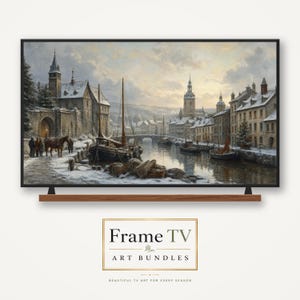 May include: A television screen displaying a winter landscape painting of a European town along a canal with boats, a stone bridge, and snow-covered buildings. Below the screen, a rectangular sign reads Frame TV ART BUNDLES.