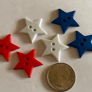 May include: Six star-shaped buttons in red, white, and blue. Each button has two holes for sewing. A US quarter is included for size comparison. These buttons are ideal for patriotic crafts.
