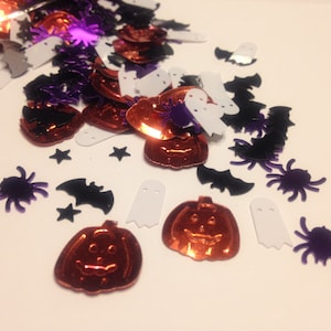 May include: Assortment of Halloween-themed confetti in orange, purple, black, and white. The confetti includes pumpkins, bats, ghosts, and spiders.