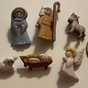 May include: A set of seven small, colorful plastic figurines depicting the Nativity scene. The figures include Mary, Joseph, a donkey, a sheep, a baby Jesus in a manger, and an angel.