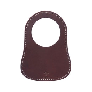 The personalized leather fuel tank bib, made from brown leather with white stitching, enhances the Classic Mini's design and safeguards against petrol spills