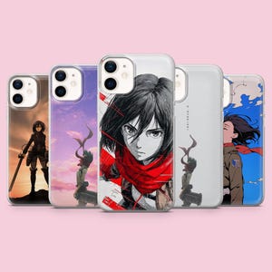 Pode incluir: Cinco capas transparentes para smartphone com várias ilustrações estilo anime de uma personagem com cabelo preto curto e cachecol vermelho. Os designs incluem fundos de pôr do sol, um retrato em close com detalhes vermelhos e céu azul.