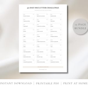 May include: A white 30-day declutter challenge printable checklist with black text, organised into a grid of thirty daily tasks with checkboxes. A circular grey badge on the right side displays the text 12 PAGE BUNDLE in black font.