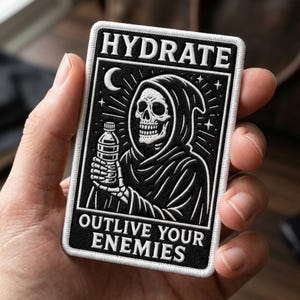 May include: A rectangular embroidered patch featuring a black and white design of a hooded skeleton holding a water bottle. The text HYDRATE is at the top and OUTLIVE YOUR ENEMIES is at the bottom. The patch has a white border and a crescent moon.
