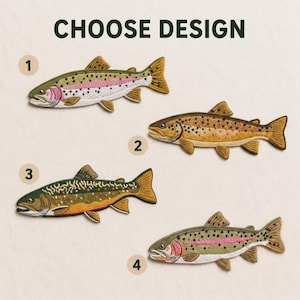 May include: Four embroidered fish patches labeled with numbers one through four under the text CHOOSE DESIGN. The patches depict various trout species with detailed scales, fins, and distinct color patterns including pink, brown, and green hues.