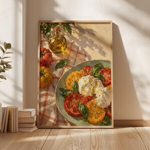 May include: A framed art print depicting a still life painting of a plate with sliced red and yellow heirloom tomatoes, fresh green basil leaves, and a mound of white burrata cheese, accompanied by a glass cruet of olive oil on a checkered cloth.