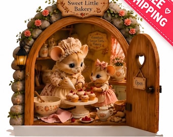 May include: A miniature bakery scene featuring two anthropomorphic mice figures inside a stone-arched structure. The sign above reads Grandma's Sweet Little Bakery. The mice are decorating cupcakes on a stand, with kitchen accessories and an open door.