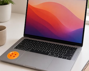 May include: A silver laptop with a black keyboard and a circular orange sticker featuring four red stars on the palm rest. The screen displays a colorful abstract wallpaper with flowing red, orange, and purple waves against a dark background.