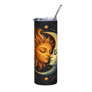 May include: A cylindrical stainless steel tumbler featuring a dark navy background with a golden sun face and a pale blue crescent moon face facing each other. The design includes scattered golden stars and a clear lid with a metal straw inserted.