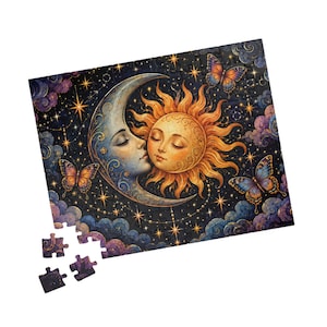 May include: A rectangular jigsaw puzzle featuring a celestial illustration of a crescent moon and a sun with human faces, surrounded by butterflies, stars, and clouds against a dark background. Three loose puzzle pieces are positioned below.