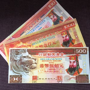 May include: Three red and gold paper bills with Chinese characters and images of people. The bills are labeled "Hellbank Note" and have denominations of 100, 500, and 1000 Hong Kong Dollars.