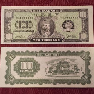 May include: Two vintage Hell Bank Notes, each with a face value of 10,000 dollars. The notes feature intricate designs, including portraits, Chinese characters, and architectural illustrations. The text "TEN THOUSAND" is prominently displayed.