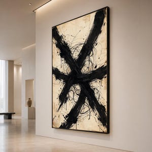 May include: A large rectangular wall art piece featuring bold, sweeping black brushstrokes that form an intersecting X shape over a textured, light beige background. The composition includes thin, chaotic black ink lines and splatters.