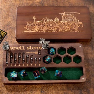 May include: A dark wood tabletop game organizer featuring a laser-engraved lid with fantasy characters and dice. The base includes a green felt-lined tray, metal tracking beads for spell slots, and hexagonal cutouts for polyhedral dice.