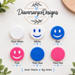 May include: Six circular discs arranged in two rows. Top row: plain white, white with a blue smiley face, and blue with a white smiley face. Bottom row: pink with a white smiley face, plain blue, and plain pink. Text reads DiaversarycoDesigns.