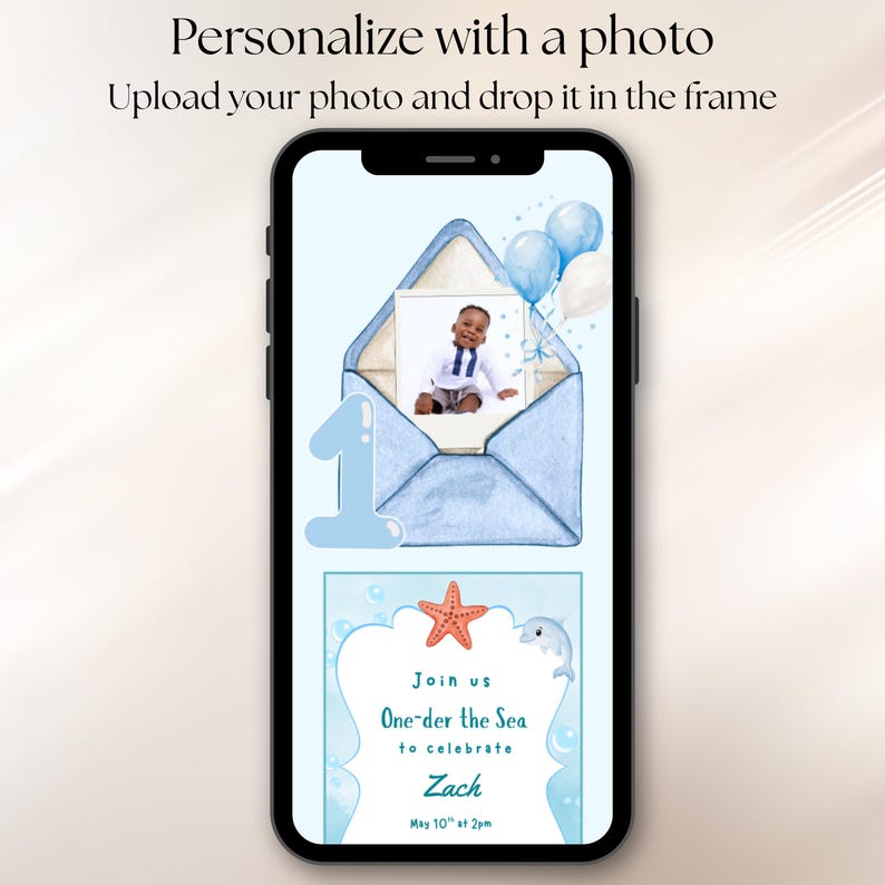 May include: A smartphone screen displaying a digital invitation template with a light blue envelope, a photo of a child, blue and white balloons, a large number one, a starfish, a dolphin, and text reading Join us One-der the Sea to celebrate Zach.