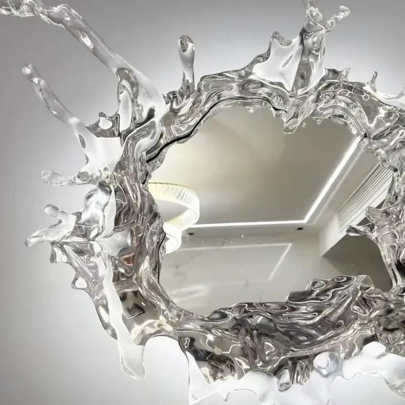 Modern LED mirror wall light featuring an artistic splash-inspired acrylic frame with an integrated decorative mirror and Modern interior featuring the water splash mirror wall light as a statement wall decoration with integrated ambient LED illumination.