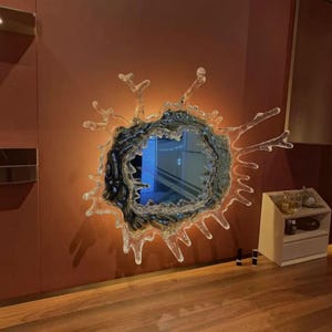 Water splash mirror wall light available in two sizes, showing the distinctive sculptural silhouette and reflective acrylic mirror surface.