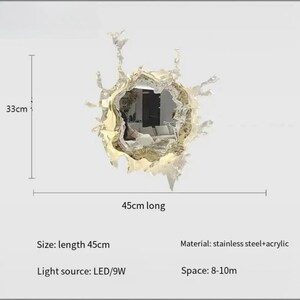 Modern LED mirror wall light featuring an artistic splash-inspired acrylic frame with an integrated decorative mirror and soft LED illumination. Contemporary wall-mounted light fixture available in gold and silver finishes, suitable for bathroom vanities, bedrooms, dressing rooms, foyers, hallways, and luxury modern interiors. Dimmable LED lighting with warm white, cool white, and tricolor options creates elegant ambient illumination and statement wall décor.