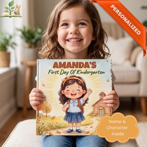May include: A personalized children's book titled Amanda's First Day Of Kindergarten featuring a cartoon illustration of a girl with a brown hair bow, blue skirt, and backpack standing in front of a school building with trees and flowers.