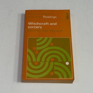 May include: A paperback book titled Witchcraft and sorcery edited by Max Marwick, part of the Penguin modern sociology Readings series. The cover is orange with white text and a graphic design featuring green concentric arcs and small orange circles.
