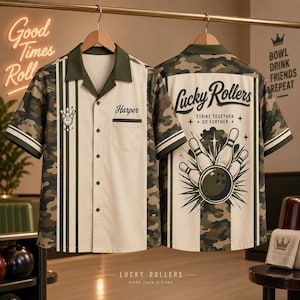 May include: A short-sleeve button-down shirt featuring a camouflage pattern on the sleeves and back, with a cream-colored front panel. The front displays the name Harper and a bowling pin icon. The back features the text Lucky Rollers.