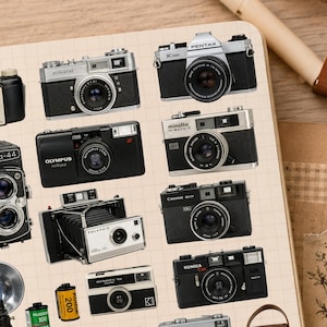 May include: A collection of vintage film cameras and accessories arranged on a grid-lined page. The set includes various models like Pentax, Olympus, Minolta, Yashica, Konica, and Polaroid, alongside film rolls, a flash unit, and a leather camera case.