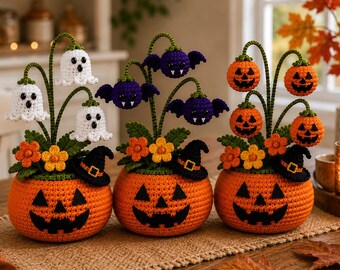 May include: Three crocheted Halloween planters, each featuring a round orange pumpkin base with a black jack-o'-lantern face. The planters are topped with green stems, orange flowers, and small black witch hats, plus white ghosts, purple bats, or orange pumpkins.