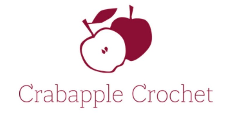 May include: A logo for a business called "Crabapple Crochet" featuring two red apples, one with a leaf and one with a slice cut out.