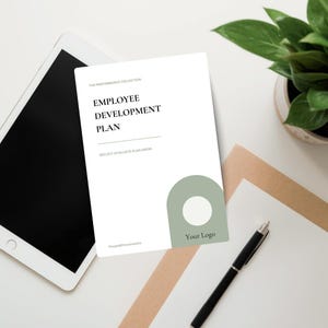 May include: A white document titled Employee Development Plan with the subtitle The Performance Collection and Reflect.Evaluate.Plan.Grow. It features a sage green arch graphic with a white circle and the text Your Logo at the bottom right.