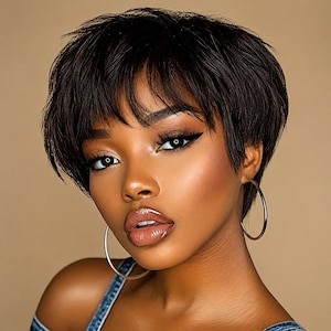 May include: A short, dark brown, layered pixie haircut with textured bangs. The style features a voluminous crown and tapered sides. Large, thin, circular gold hoop earrings are worn, and the garment is a blue denim strap top.