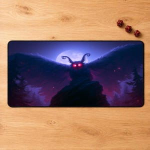 May include: A rectangular desk mat featuring a dark, atmospheric illustration of a moth-like creature with glowing red eyes and expansive wings, perched on a rock against a large full moon, surrounded by silhouettes of pine trees in purple hues.